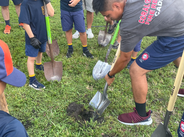 A Coral Gables Fire Rescue Cadet demonstrated the use of a shovel to St. Theresa Pack 16 Boy Scouts, who would later employ his same tactics to plan trees inside Gables' spaces. 